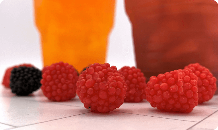 Raspberries in Front of the Cups With Loaded Tea