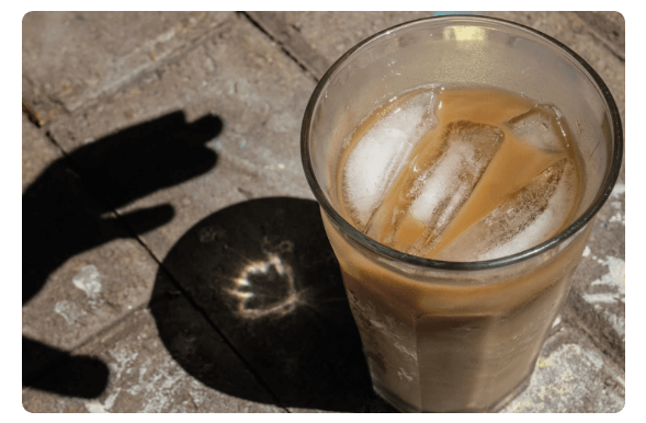 Shadow of a Hand Reaching for Coffee | Melinda Podor, Getty Images