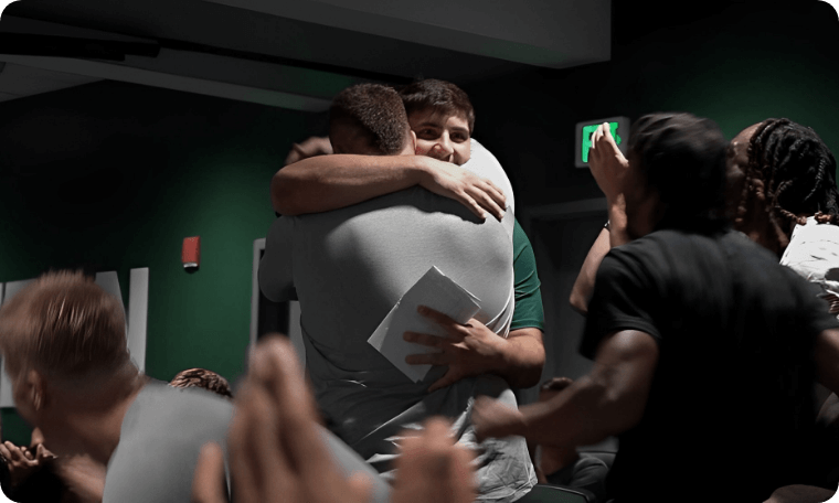 Two Guys Hugging Each Other in Celebration